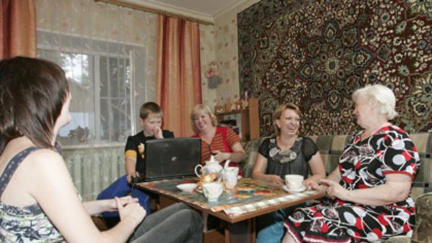In from the cold ... a Moscow  family in their  apartment, which has carpeted walls. In the dark, cold winters, Russians revert to the urban habits of continental Europe.