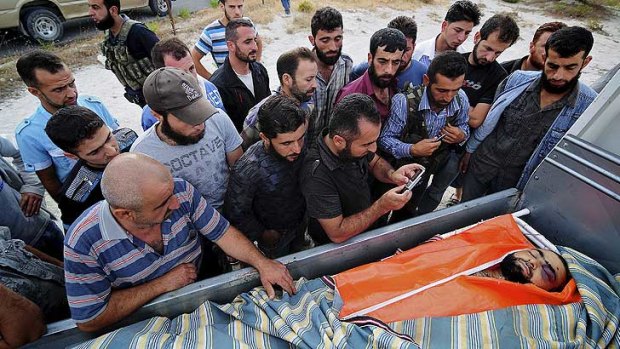 The body of farmer Mohammed Aziz Mehho arrives back at his village for burial. He was shot from a Syrian Army helicopter.