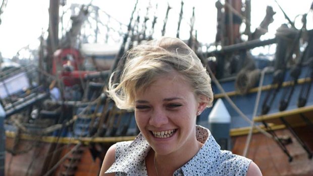 Jessica Watson stands near the replica of Captain James Cook's famous ship.