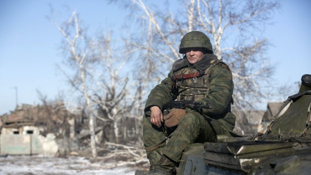 A fighter with separatist self-proclaimed Donetsk People's Republic army sits on top of an armoured personnel carrier in the village of Nikishine, south-east of Debaltseve.