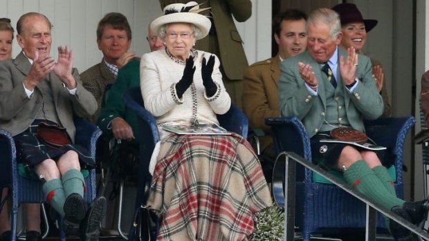 Old guard: The Duke of Edinburgh, Queen Elizabeth and Prince Charles watch the action during the Braemar Highland Games. 