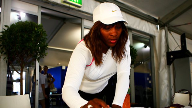 Sign here, please ... Serena Williams at Olympic Park yesterday.