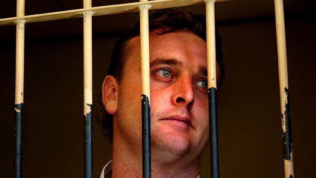 Australian Martin Stephens waits in the holding cell behind Denpasar's court complex, moments before he is ushered in to the courtoom to be sentenced.