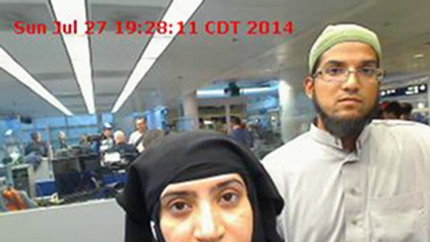 San Bernardino shooters Tashfeen Malik, left, and Syed Farook pictured passing through O'Hare Airport in Chicago in July 2014.