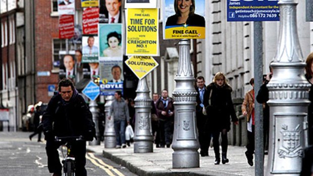 Posters line a Dublin street on the eve of elections tipped to oust Fianna Fail.