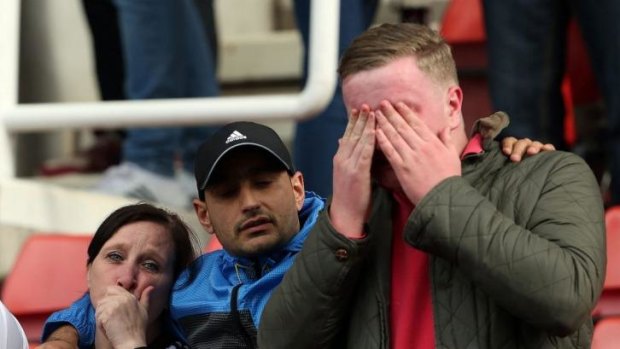 Fulham fans show their emotions after relegation is confirmed.