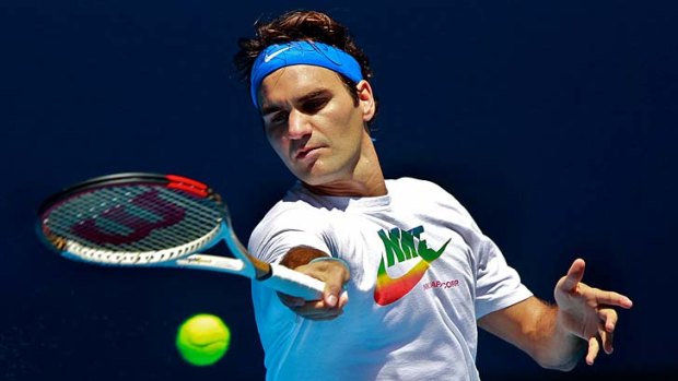 Easing in... Roger Federer practises at Melbourne Park on Sunday for the Australian Open.