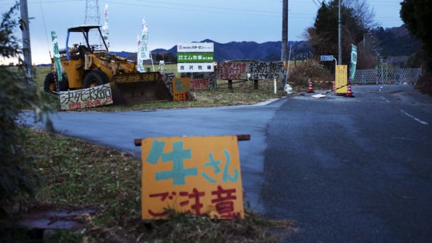A bulldozer stands at the entrance of the Farm of Hope in Namie, Japan.