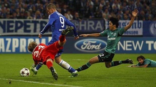 Chelsea's Fernando Torres (9) scores as Schalke 04's goalkeeper Timo Hildebrand dives in desperation during their Champions League encounter on Tuesday.