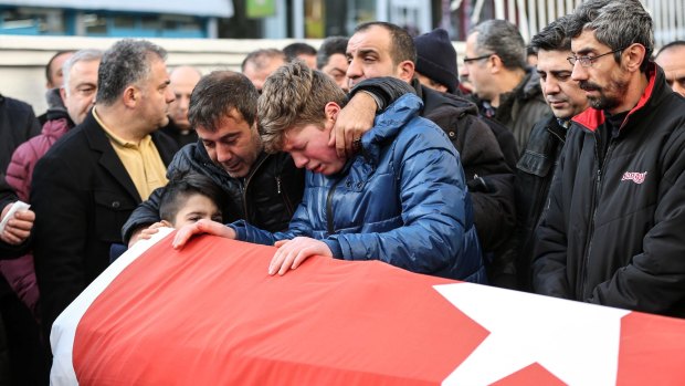 Relatives and friends mourn Ayhan Arik, one of the 39 victims of the nightclub attack.