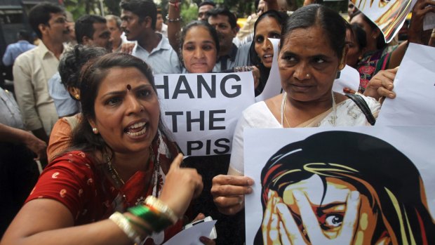 String of sex attacks: Indian activists shout slogans as they protest against the gang-rape of a 22-year-old photojournalist in Mumbai in 2013. 