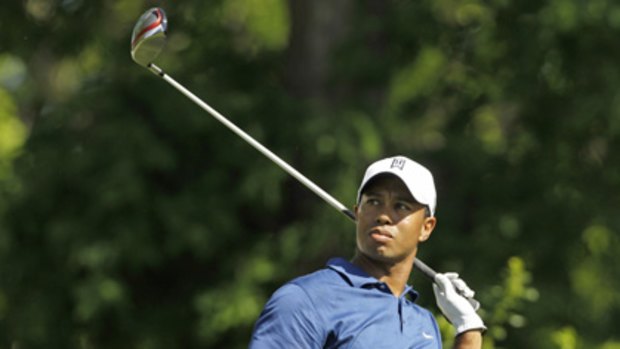 Off day ... Tiger Woods reacts after hitting his tee shot on the 15th.