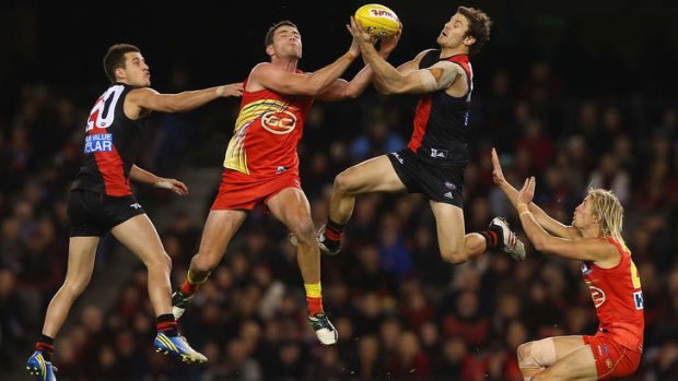 Bombers fly up: Ben Howlett of the Bombers attempts to mark over the top of Thomas Murphy of the Suns.