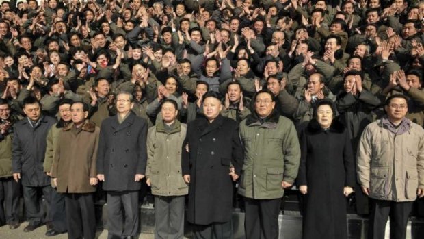 Not a single bourgeois ponytail in sight ...North Korean leader Kim Jong Un poses for a photo with some of his followers.