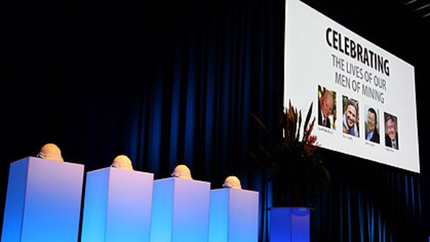 Four miner's helmets adorn the stage during the memorial for the Sundance plane crash victims.