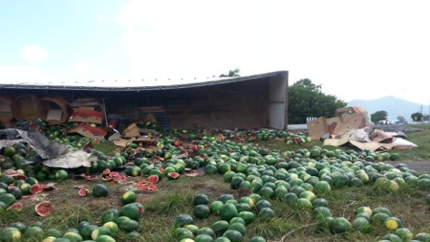 Watermelons spill down a grassy verge after a truck crashed north of Cairns.
