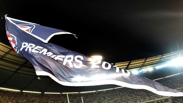 Collingwood's 2010 AFL Premiership flag is unfurled at the MCG before the match against Carlton.