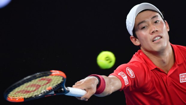 Japan's Kei Nishikori reaches to play a forehand to Switzerland's Roger Federer during their fourth round match at the Australian Open.