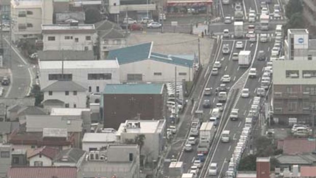 A long line of vehicles  waits to fill  up with petrol  at Ageo, north of Tokyo today.