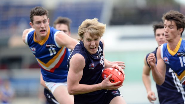 Good genes: Hugh Goddard (centre), younger cousin of Brendon, in action with the Falcons.