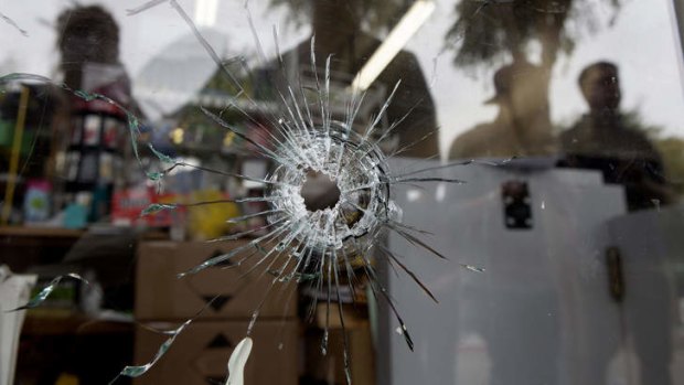 A bullet hole in the window of the IV Deli Mart, which Elliot Rodger reportedly targeted.