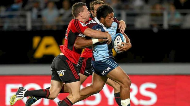 George Moala of the Blues is tackled.