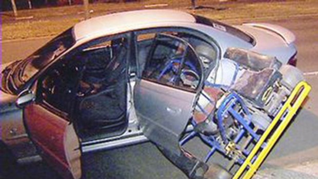 Tight fit ... three men attempting to steal a go-kart came unstuck when they tried to fit it into the back of this Holden Commodore .