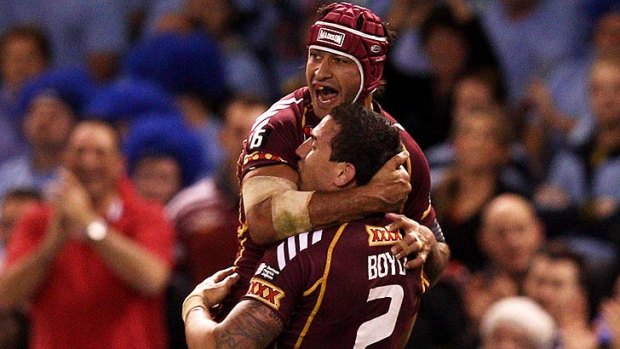 Johnathan Thurston and Darius Boyd celebrate a Maroons try.