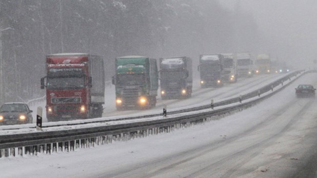 Chaos ... Trucks drive along the snow-covered A12 motorway near Frankfurt.