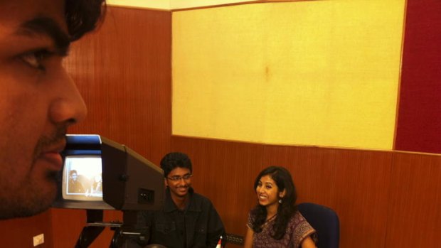 Aspiring television anchors Siddharth Karthikeyan (left) and Rakisha Bihani are filmed as they play the role of hosts for the day in their Chennai morning program.