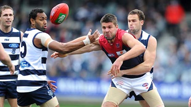 Surrounded: Melbourne ruckman Mark Jamar is hopelessly outnumbered by Geelong players.