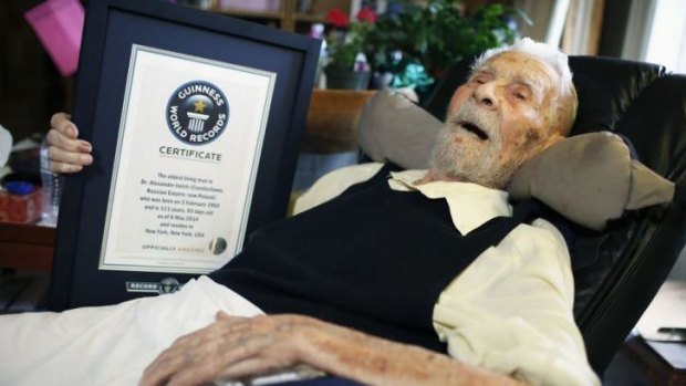 A long and interesting life ... 111-year-old Alexander Imich holds a Guinness World Records certificate recognising him as the world's oldest living man at his home in New York on May 9, 2014.