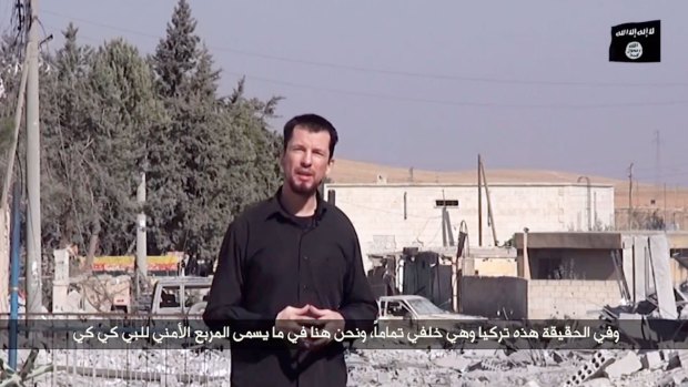 An image grab taken from a video released by the Islamic State (IS) group purportedly shows 43-year-old kidnapped British reporter John Cantlie.