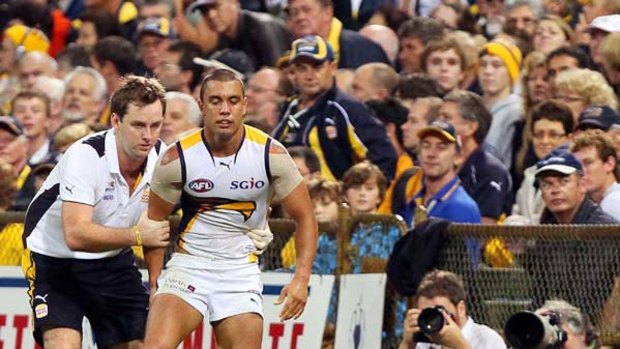 West Coast's Daniel Kerr gets assistance from a trainer after injuring his hamstring.