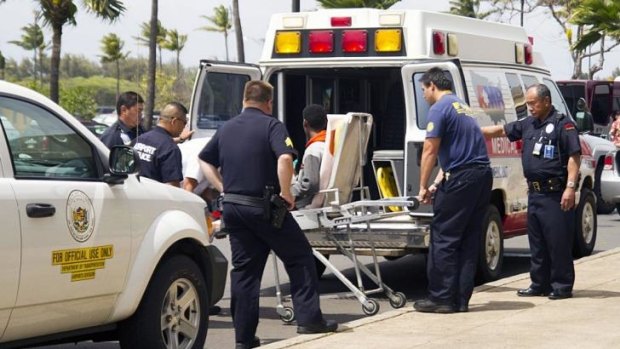 A 16-year-old boy who stowed away on a flight to Hawaii is loaded into an ambulance at Kahului Airport in Maui.
