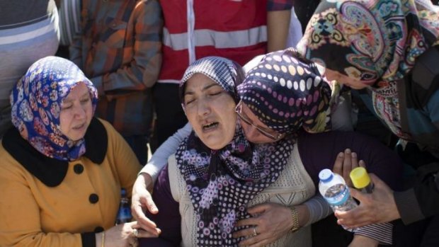 Relatives at the graveside of one of the miners killed in the disaster.