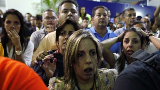 Result in dispute: Disappointed supporters of the opposition presidential candidate, Henrique Capriles, react after the result in Caracas.