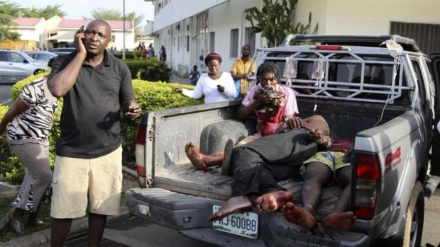 Injured victims of a bomb attack wait at the back of a pickup truck at the Asokoro General Hospital in Abuja, Nigeria.