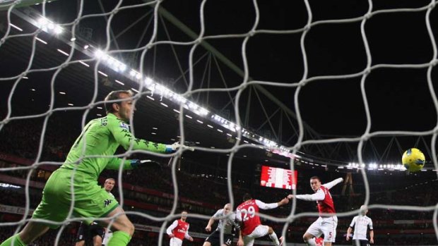 Out of reach ... Mark Schwarzer can only look on as Thomas Vermaelen powers his header into the net for Arsenal's equaliser. The Socceroo made several vital saves for his side in their draw at the Emirates Stadium.