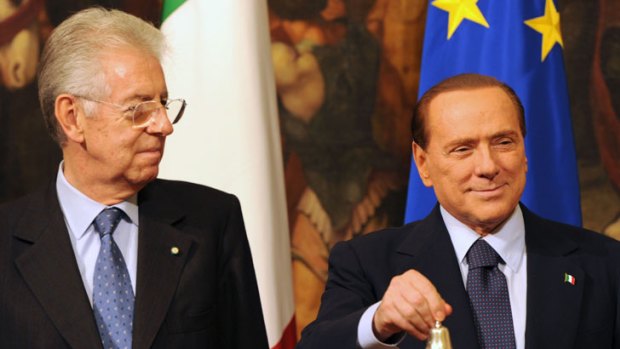 Silvio Berlusconi prepares to give the bell to Italy's new prime minister, Mario Monti, signifying the change of the country's leadership.