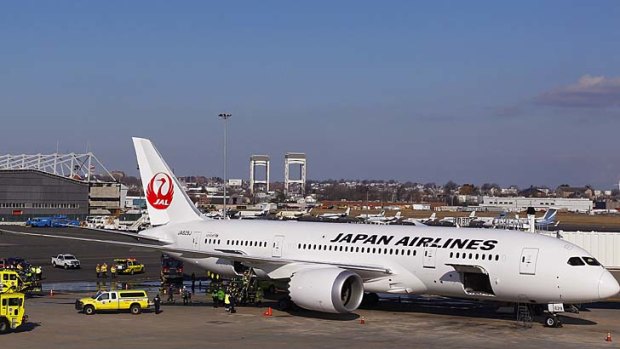 The Japan Airlines Boeing 787 Dreamliner jet aircraft is surrounded by emergency vehicles at Logan International Airport in Boston.