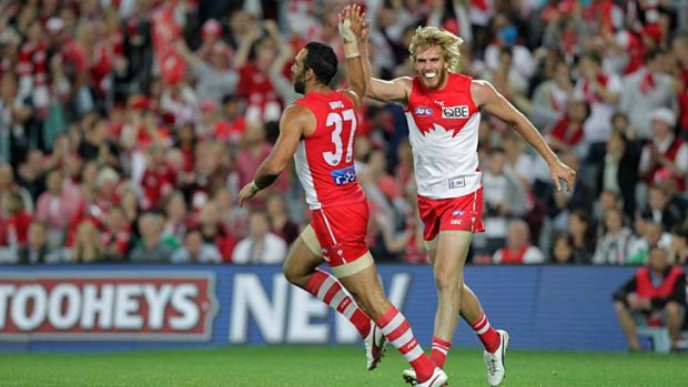 Swans on song: Adam Goodes and Lewis Roberts-Thomson celebrate a goal last night against Collingwood.
