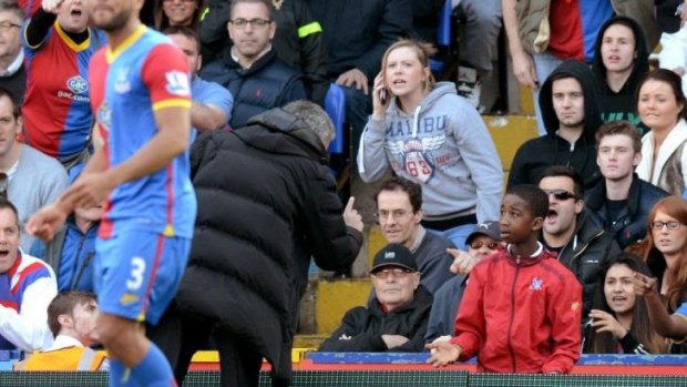 Chelsea manager Jose Mourinho has words with a Crystal Palace ball boy.