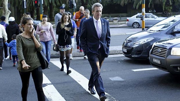 Now just a man on the street: Barry O'Farrell walks across Macquarie Street.