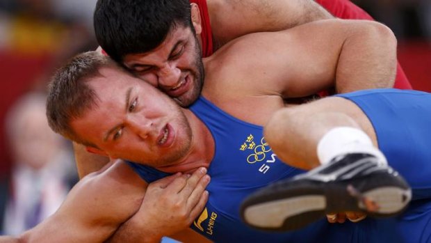 Azerbaijan's Shalva Gadabadze (in red) fights with Sweden's Jimmy Lidberg in round two.