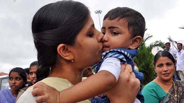 An Indian nurse, who was among 46 nurses stranded in territory held by Islamic extremists in Iraq, kisses her nephew upon arrival in Kochi.
