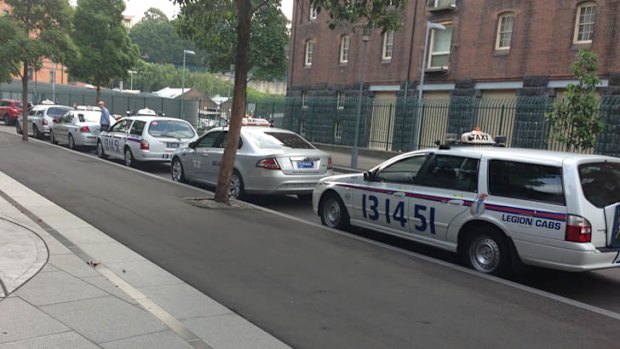 Taxis wait outside Fairfax Media's Sydney office.