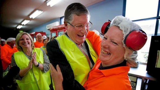 Just peachy: Premier Denis Napthine gives plastics operator Robyn Tuffnal a hug.
