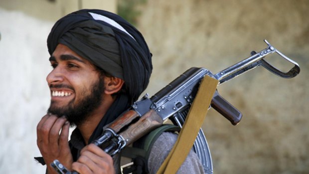 A Taliban militant outside a mosque in Daggar.