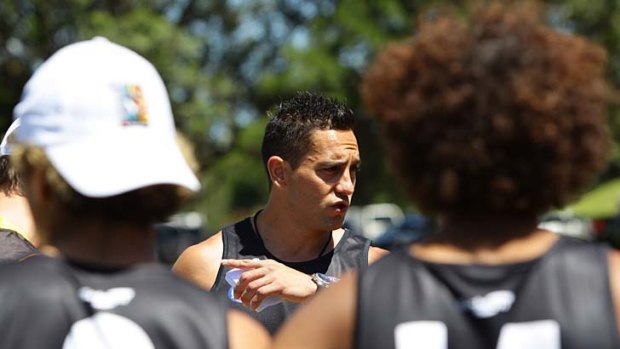 Leading from the front: Andrew McLeod, as coach, talks to the Flying Boomerangs at a training camp in Sydney.
